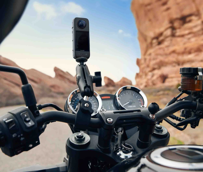 Insta360 X3 action camera attached to a motorcycle handlebar