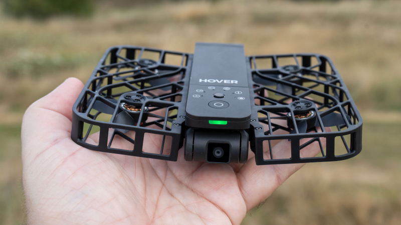 Hand holding the folded HOVERAir X1 drone