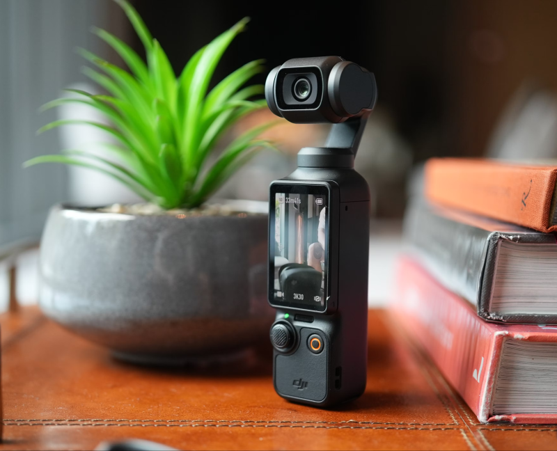 DJI Osmo Pocket 3 vlogging camera placed in a stylish setting with books in the background