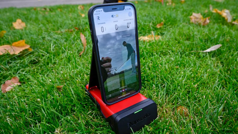 Rapsodo Mobile Launch Monitor on golf course with player taking a swing